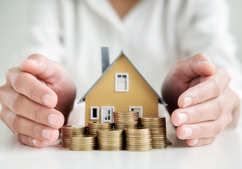 Saving,Money,For,House,And,Real,Estate.,Woman,Hand,Protecting